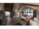 Spacious living room with high ceilings, wood paneling, and a large window overlooking the property at 139 Cricket Creek Dr, Cherryville, NC 28021