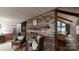 Comfortable living room featuring a brick fireplace, hardwood floors, and leather chairs at 139 Cricket Creek Dr, Cherryville, NC 28021