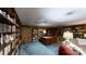 Spacious office with extensive built-in bookshelves, a large desk, and comfortable seating at 139 Cricket Creek Dr, Cherryville, NC 28021