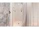 Clean, updated white tiled shower with grab bar and handheld shower head at 139 Cricket Creek Dr, Cherryville, NC 28021