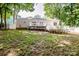 Beautiful backyard featuring a deck, lush trees, and a white fence at 146 Valley Glen Dr, Troutman, NC 28166