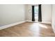 Bright bedroom featuring hardwood floors and a window with dark curtains at 146 Valley Glen Dr, Troutman, NC 28166