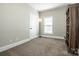 Spacious bedroom with carpet, a window with blinds, and a built-in bookshelf at 146 Valley Glen Dr, Troutman, NC 28166