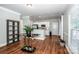 Open dining area showcasing hardwood floors connecting to a kitchen with white cabinets and stainless steel appliances at 146 Valley Glen Dr, Troutman, NC 28166