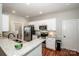 Well-lit kitchen features stainless steel appliances, granite countertops, and white cabinets at 146 Valley Glen Dr, Troutman, NC 28166