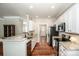 Open-concept kitchen features granite counters, stainless appliances, and custom cabinets at 146 Valley Glen Dr, Troutman, NC 28166