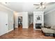 Open-concept living room featuring hardwood floors, fireplace, and seamless flow to kitchen at 146 Valley Glen Dr, Troutman, NC 28166
