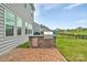 Outdoor kitchen and grill on the patio of a home with grey siding at 14734 Rivergate Pkwy, Charlotte, NC 28273
