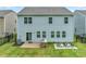 Backyard features a brick patio, grill, garden boxes, and a well-manicured lawn at 14734 Rivergate Pkwy, Charlotte, NC 28273