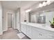 Bright bathroom with double sink vanity, white cabinets and a large mirror, next to walk-in shower at 14734 Rivergate Pkwy, Charlotte, NC 28273