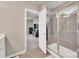 Bathroom showing walk-in shower with glass doors and adjacent bedroom visible through an open door at 14734 Rivergate Pkwy, Charlotte, NC 28273
