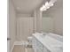 Neutral bathroom features a single sink, vanity, tub, and shower with tan tiled floors at 14734 Rivergate Pkwy, Charlotte, NC 28273