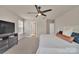 Bedroom with carpet, ceiling fan, mounted television and view into the hallway and other rooms at 14734 Rivergate Pkwy, Charlotte, NC 28273