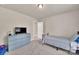 Bedroom boasts neutral walls, plush carpet, a TV, and a cozy twin bed at 14734 Rivergate Pkwy, Charlotte, NC 28273