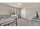 Bedroom with neutral walls, carpet, window, and a black metal bed frame at 14734 Rivergate Pkwy, Charlotte, NC 28273