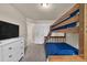Bedroom with a wooden bunk bed and a white dresser with a TV on top of it at 14734 Rivergate Pkwy, Charlotte, NC 28273