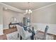 Bright dining area with elegant lighting, table, and a decorative console, creating a stylish and inviting space at 14734 Rivergate Pkwy, Charlotte, NC 28273