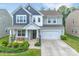 Charming two-story home featuring a covered front porch, two-car garage, and beautifully landscaped front yard at 14734 Rivergate Pkwy, Charlotte, NC 28273