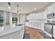 Bright kitchen with stainless steel appliances, white cabinets, and a center island with ample countertop space at 14734 Rivergate Pkwy, Charlotte, NC 28273