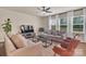 Spacious living room with comfortable sofas, a modern entertainment center, and bright natural light at 14734 Rivergate Pkwy, Charlotte, NC 28273