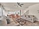 Spacious living room with modern furniture, ceiling fan and adjacent kitchen with island and barstool seating at 14734 Rivergate Pkwy, Charlotte, NC 28273