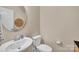Cozy powder room featuring a pedestal sink, round mirror, and neutral color palette for a serene feel at 14734 Rivergate Pkwy, Charlotte, NC 28273
