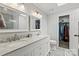 Bright bathroom featuring a double vanity with marble countertop, walk-in closet and modern fixtures at 1543 Newfound Hollow Dr, Charlotte, NC 28214