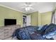 Bedroom featuring ceiling fan, large bed, wooden dresser, and view of the backyard at 1543 Newfound Hollow Dr, Charlotte, NC 28214