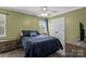 Comfortable bedroom featuring a ceiling fan, large bed and window at 1543 Newfound Hollow Dr, Charlotte, NC 28214