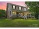 Charming two-story home with a covered front porch, landscaped yard, and beautiful curb appeal at 1543 Newfound Hollow Dr, Charlotte, NC 28214