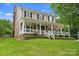 Charming two-story home with a covered front porch, landscaped yard, and beautiful curb appeal at 1543 Newfound Hollow Dr, Charlotte, NC 28214