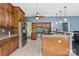 Open-concept kitchen featuring stainless steel appliances, granite countertops, wooden cabinets and breakfast bar at 1543 Newfound Hollow Dr, Charlotte, NC 28214
