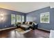 Cozy living room with a comfortable sectional sofa, hardwood floors, and natural light at 1543 Newfound Hollow Dr, Charlotte, NC 28214