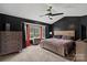 Comfortable main bedroom featuring a ceiling fan, black accent wall and large window with natural light at 1543 Newfound Hollow Dr, Charlotte, NC 28214
