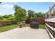 Backyard patio with a charcoal grill, furniture, wooden privacy fence and manicured lawn at 175 Mcleod Ave, Belmont, NC 28012