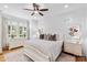 Bright bedroom with windows, hardwood floors, a ceiling fan, and elegant white furniture at 175 Mcleod Ave, Belmont, NC 28012
