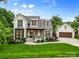 Charming home exterior featuring a lush lawn, beautifully landscaped yard, and detached garage with ample parking at 175 Mcleod Ave, Belmont, NC 28012