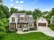 Stunning exterior showcasing lush landscaping, a manicured lawn, and a charming home with a detached garage at 175 Mcleod Ave, Belmont, NC 28012