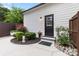Exterior view showing the back entrance with a concrete path and well maintained landscaping at 175 Mcleod Ave, Belmont, NC 28012