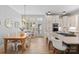 Bright eat-in kitchen with a large island, modern lighting, and a seamless flow into the dining area at 175 Mcleod Ave, Belmont, NC 28012