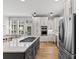 Elegant kitchen with custom cabinetry, a central island cooktop, and stainless steel appliances at 175 Mcleod Ave, Belmont, NC 28012