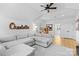 Open-concept living room featuring a large sectional sofa, ceiling fan, and hardwood flooring at 175 Mcleod Ave, Belmont, NC 28012
