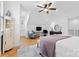 Bright main bedroom featuring hardwood floors, ceiling fan, and a decorative shelving unit at 175 Mcleod Ave, Belmont, NC 28012