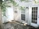 Enclosed back patio with a small window and a convenient side door for easy access to outdoor space at 1911 Flushing Ct, Charlotte, NC 28215
