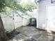 Small back patio with white picket fence and siding. Perfect for relaxing outdoors at 1911 Flushing Ct, Charlotte, NC 28215