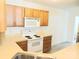 Features a white oven, microwave and light oak cabinets at 1911 Flushing Ct, Charlotte, NC 28215