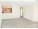 Open-concept floor plan with plush gray carpeting and a view into the adjacent kitchen area at 1911 Flushing Ct, Charlotte, NC 28215