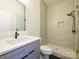 This bathroom is equipped with a step-in shower with tile surround, and a modern vanity at 2004 Plain Field Dr, Bessemer City, NC 28016