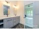 Modern bathroom featuring double sinks, elegant fixtures, and a view into an adjacent bedroom at 2004 Plain Field Dr, Bessemer City, NC 28016