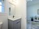 Updated half bathroom boasts modern vanity and fixtures, with a glimpse into the living area at 2004 Plain Field Dr, Bessemer City, NC 28016